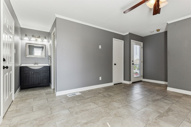 entryway with light tile patterned flooring, sink, ornamental molding, and ceiling fan