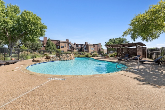 view of pool with pool water feature and a patio area