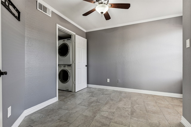 laundry room with stacked washer / dryer, ceiling fan, ornamental molding, and light tile patterned floors