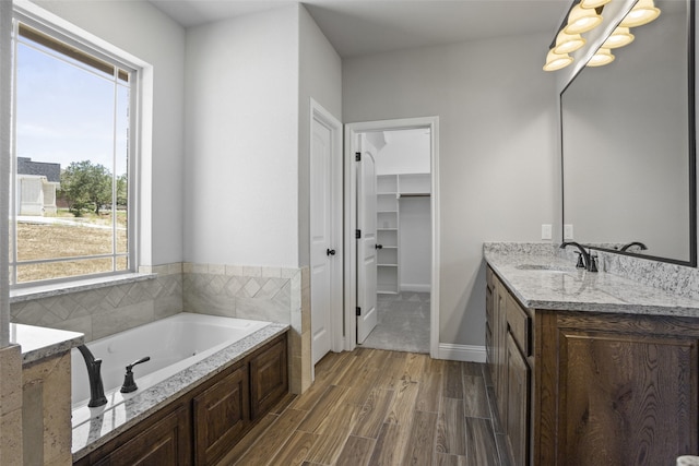 bathroom featuring vanity, a bathing tub, and hardwood / wood-style flooring