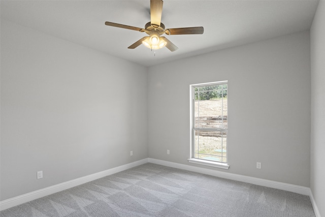 empty room with ceiling fan and light carpet