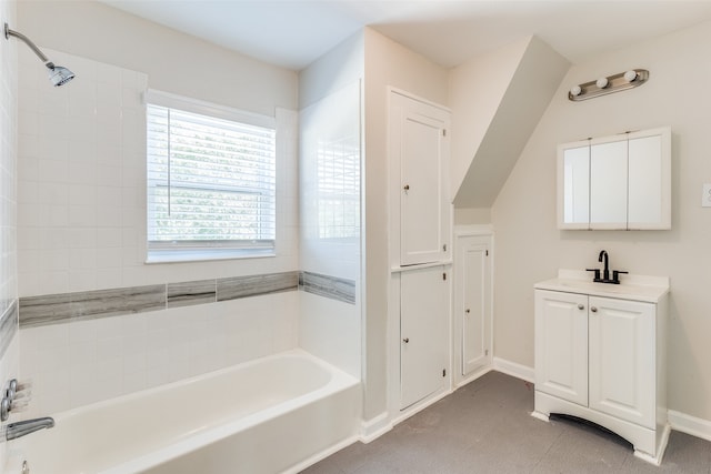 bathroom with tiled shower / bath combo, vanity, and tile patterned floors