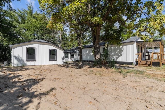 back of property with a wooden deck