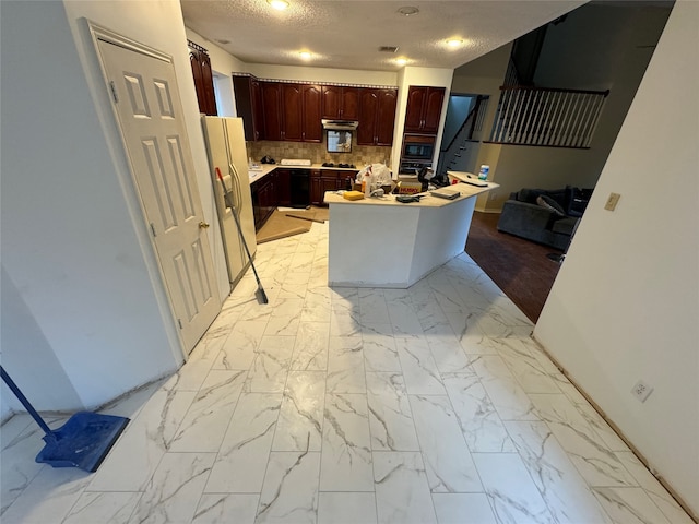 kitchen featuring decorative backsplash, a kitchen island, built in microwave, light countertops, and white fridge with ice dispenser