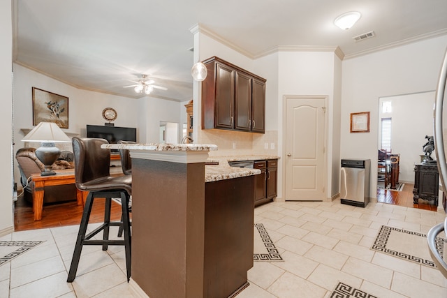 kitchen with decorative backsplash, dark brown cabinetry, crown molding, light wood-type flooring, and kitchen peninsula