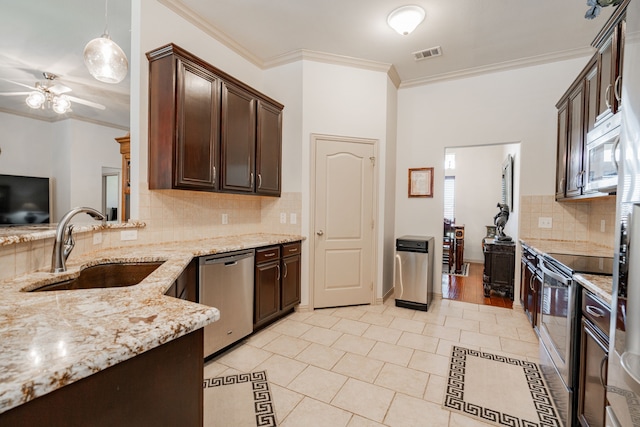 kitchen with stainless steel appliances, light hardwood / wood-style flooring, ornamental molding, and tasteful backsplash