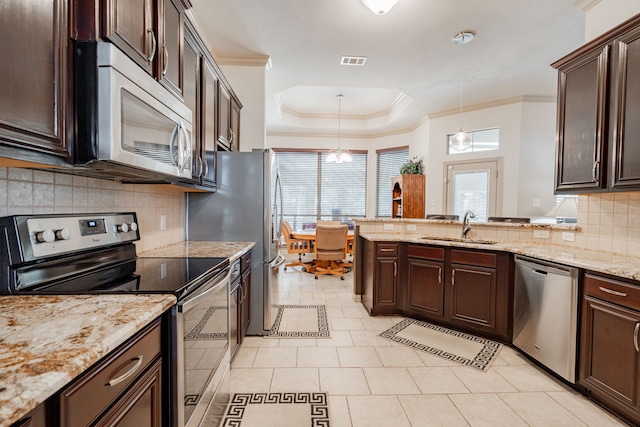 kitchen featuring decorative backsplash, appliances with stainless steel finishes, light stone counters, sink, and light tile patterned flooring