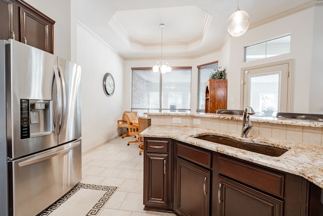 kitchen with dark brown cabinetry, sink, a raised ceiling, stainless steel fridge with ice dispenser, and light tile patterned floors