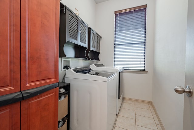 clothes washing area with washing machine and clothes dryer and light tile patterned floors