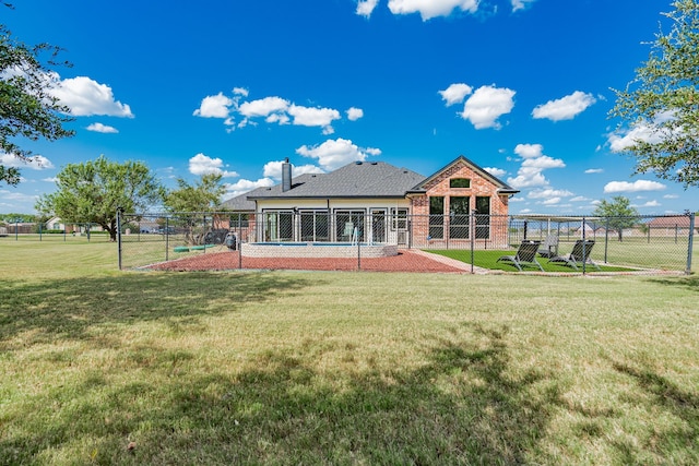 rear view of property with a lawn