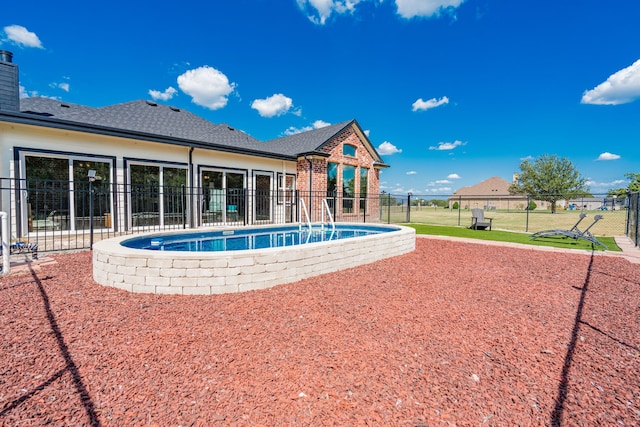 view of swimming pool featuring a lawn