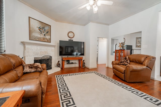 living room with ceiling fan, a fireplace, dark wood-type flooring, and ornamental molding