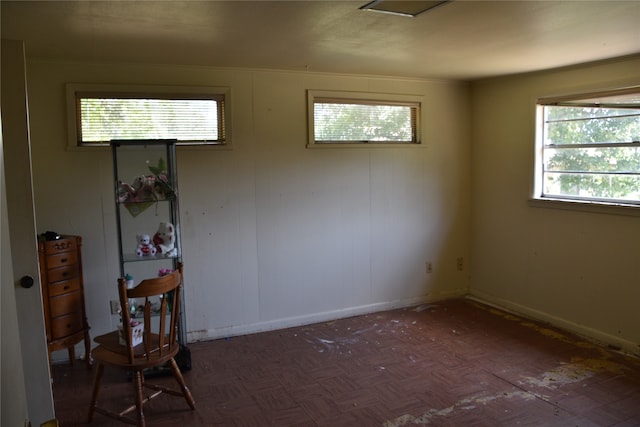 interior space with a healthy amount of sunlight and dark parquet flooring