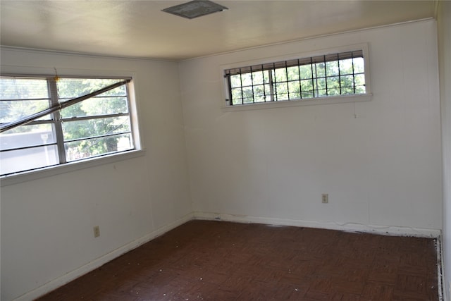 unfurnished room with a wealth of natural light and parquet floors