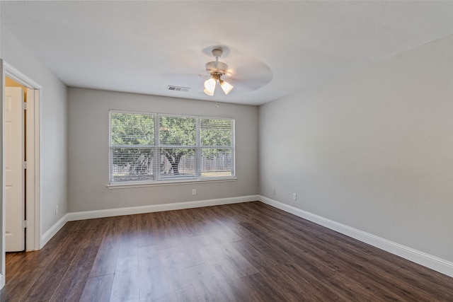 unfurnished room with ceiling fan and dark wood-type flooring