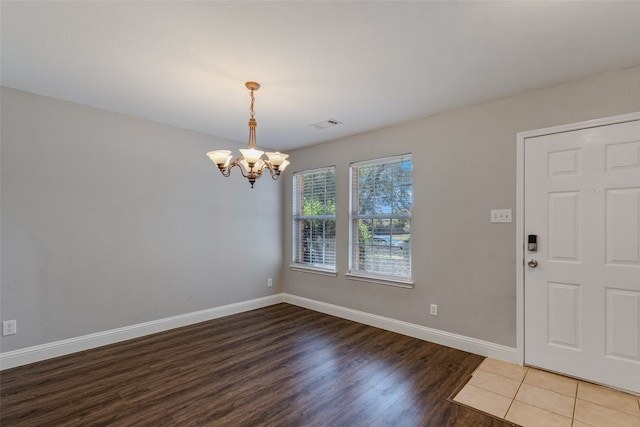 entryway featuring hardwood / wood-style floors and a chandelier