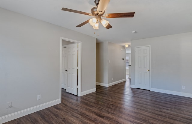 empty room with ceiling fan and dark wood-type flooring