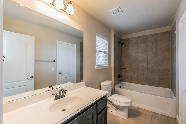 full bathroom featuring vanity, tiled shower / bath, tile patterned floors, and toilet