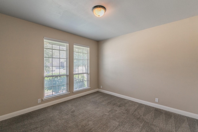 empty room featuring dark carpet