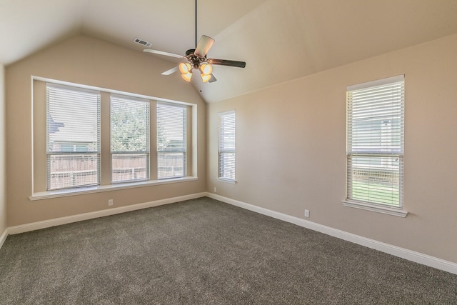 unfurnished room featuring dark carpet, ceiling fan, and vaulted ceiling