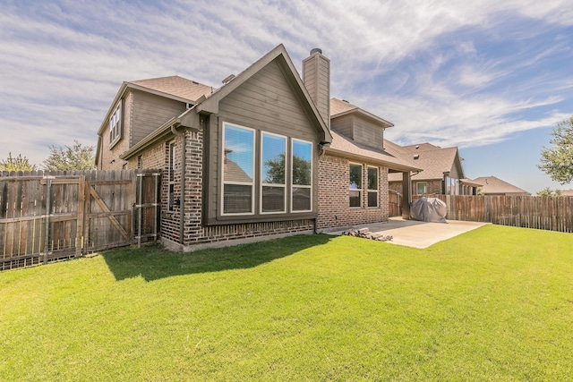 back of property featuring a yard and a patio area