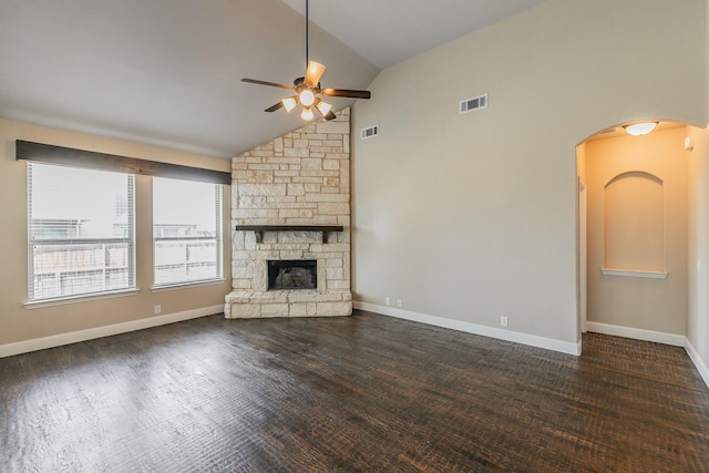 unfurnished living room with lofted ceiling, dark wood-type flooring, a fireplace, and ceiling fan