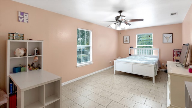 tiled bedroom featuring ceiling fan