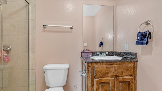 bathroom featuring toilet, vanity, and walk in shower