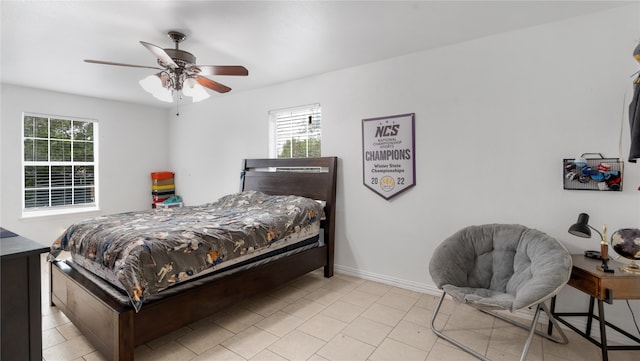 bedroom with ceiling fan and light tile patterned floors