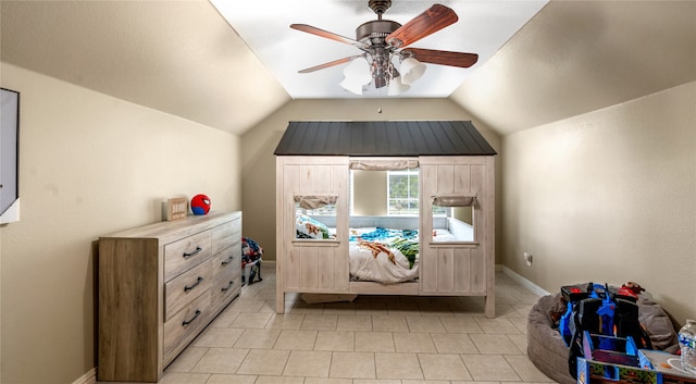 unfurnished bedroom featuring ceiling fan, light tile patterned flooring, and lofted ceiling