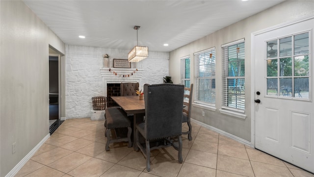 tiled dining space featuring a fireplace