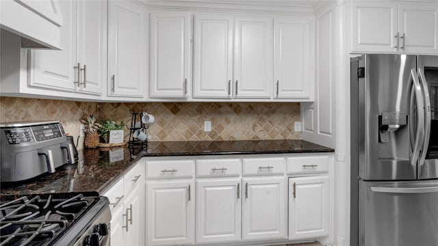 kitchen with white cabinets, backsplash, and stainless steel appliances