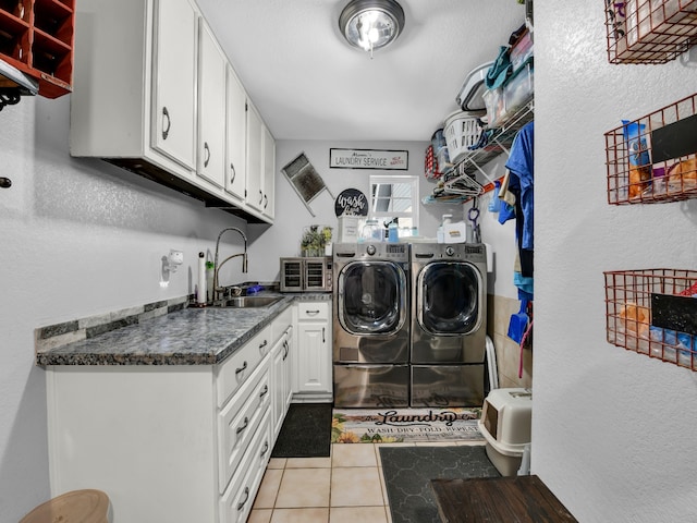 laundry room with light tile patterned floors, sink, independent washer and dryer, and cabinets