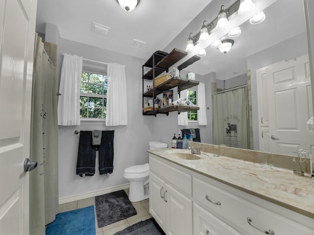 bathroom featuring toilet, vanity, and tile patterned floors