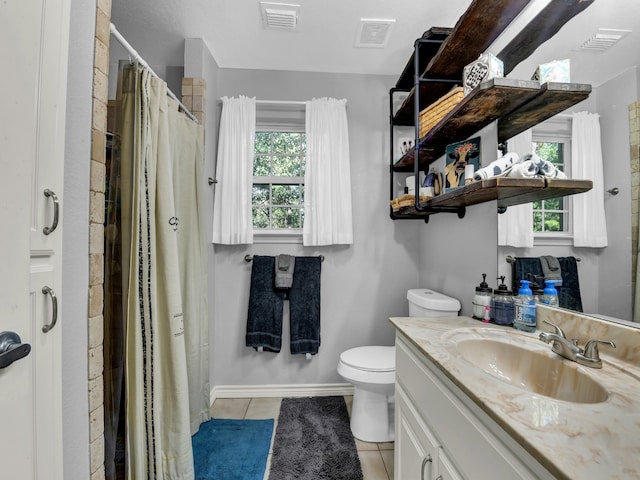 bathroom with tile patterned flooring, toilet, and vanity