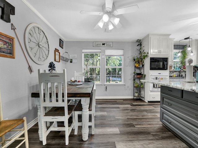 dining room with ceiling fan, crown molding, and dark wood-type flooring