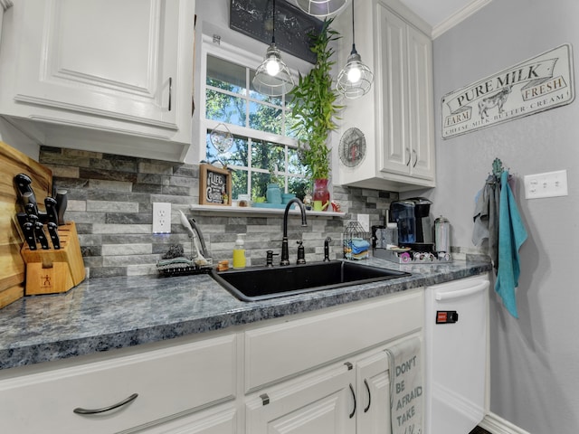 kitchen featuring white cabinetry, white dishwasher, pendant lighting, and decorative backsplash