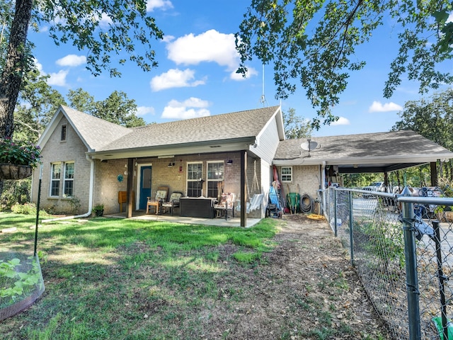 back of house with a lawn