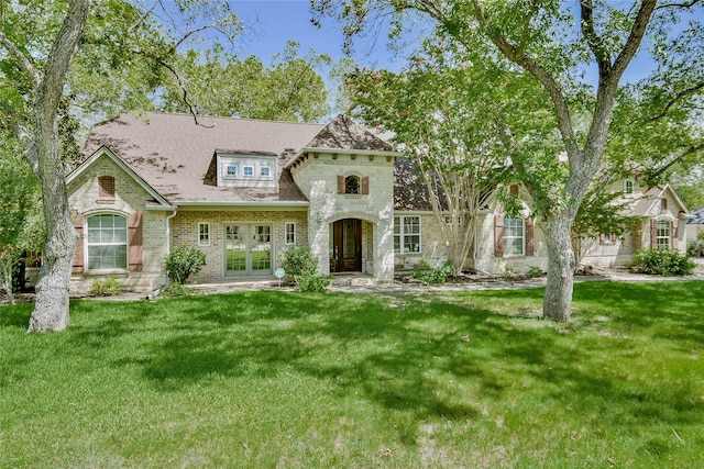 view of front of home featuring a front yard and french doors