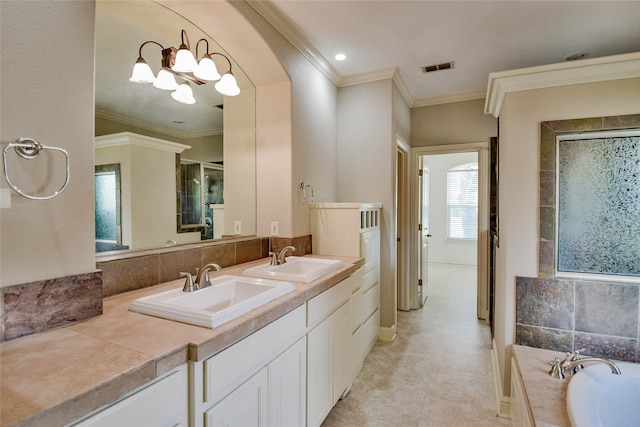 bathroom with tile patterned flooring, a bathtub, double sink vanity, and ornamental molding