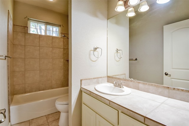 full bathroom with tiled shower / bath combo, tile patterned floors, toilet, and vanity