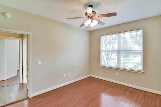 unfurnished room with hardwood / wood-style floors and ceiling fan