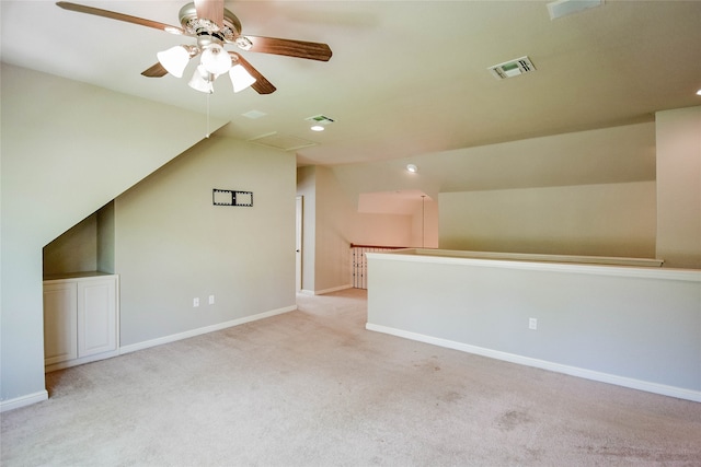 additional living space featuring ceiling fan, light carpet, and lofted ceiling