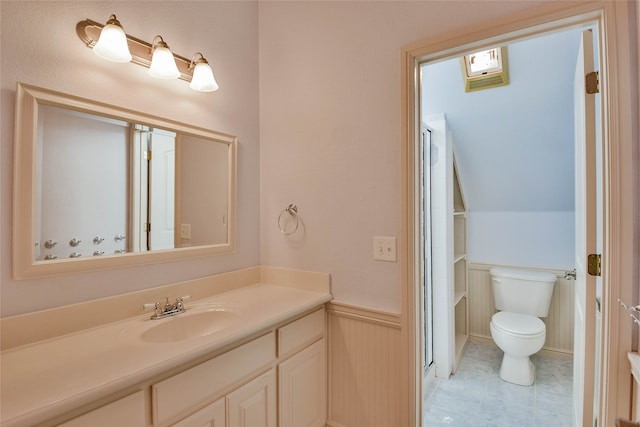 bathroom with tile patterned flooring, vanity, and toilet