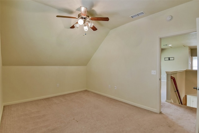 additional living space featuring ceiling fan, light carpet, and lofted ceiling