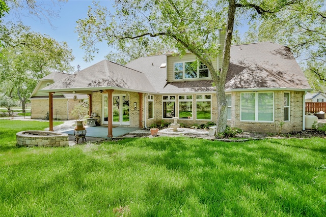 back of property featuring a patio area and a yard