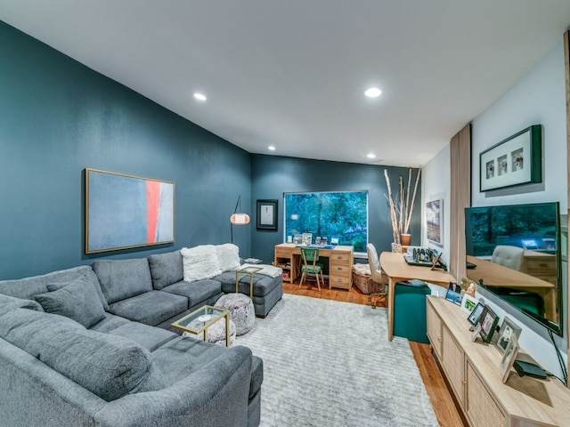 living room with vaulted ceiling and light hardwood / wood-style floors