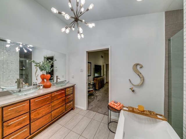 bathroom featuring tile patterned floors, vanity, a chandelier, vaulted ceiling, and a shower with shower door