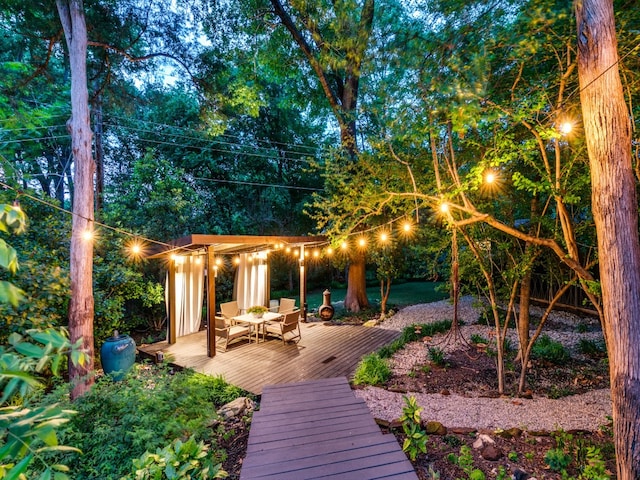 back of house featuring a deck and a pergola