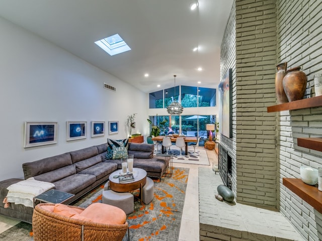 living room featuring brick wall, a brick fireplace, and a skylight